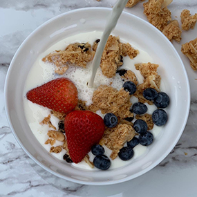 Bowl of GoodieKrunch with berries and milk